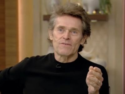 Willem Dafoe is using his hands while talking.